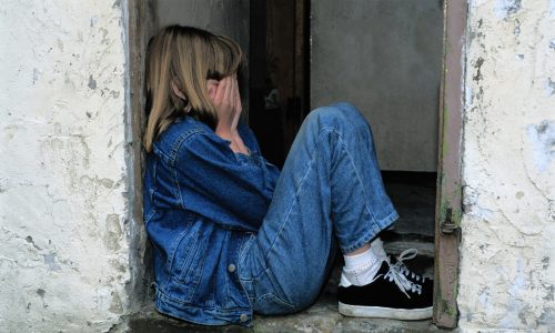 girl hands covering face