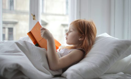 girl reading an orange book how to better memorised a script
